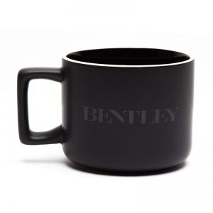 Black ceramic mug with white lip and logo.